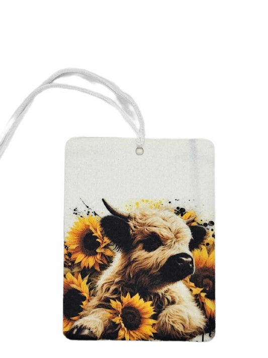 Baby highland cow and sunflowers