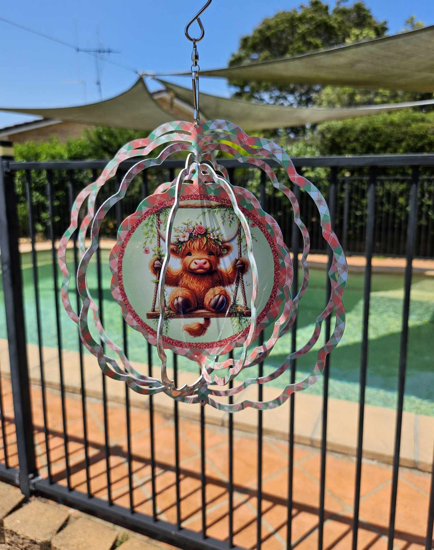 Cute highland cow on a swing