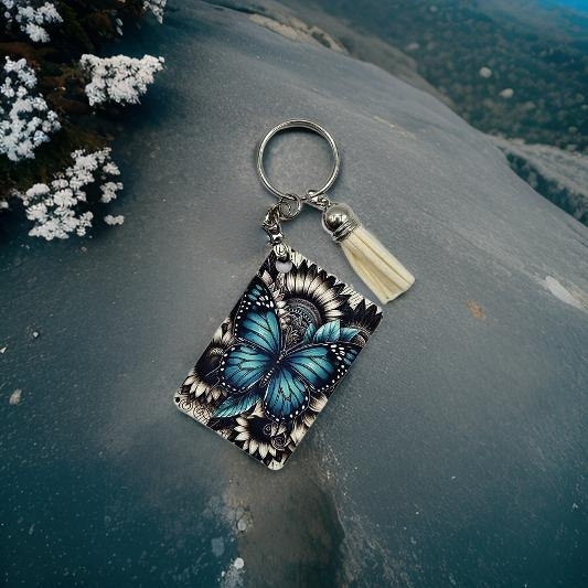Teal butterfly with black and white floral